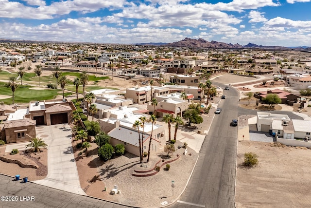 drone / aerial view featuring a residential view, a mountain view, and view of golf course