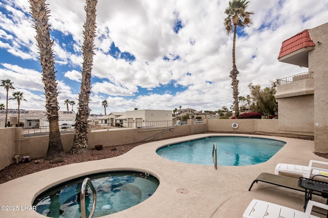 pool with a residential view, a patio, a fenced backyard, and a hot tub