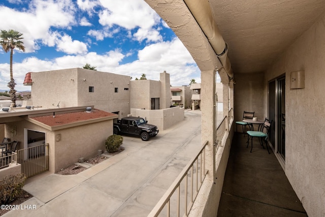 view of patio with a residential view and a balcony