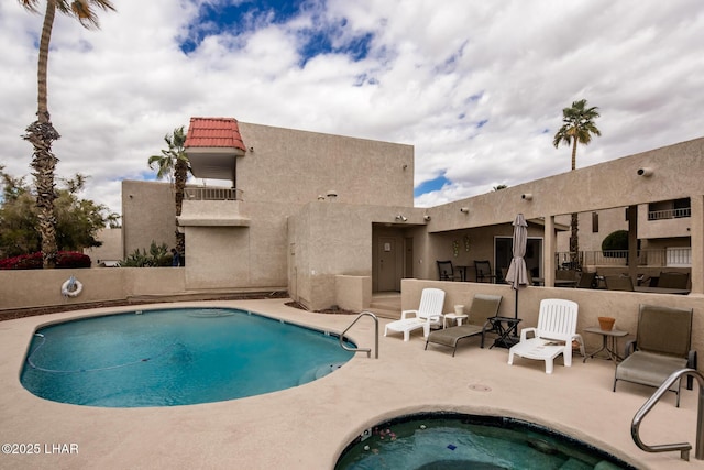 pool featuring a patio area and a community hot tub