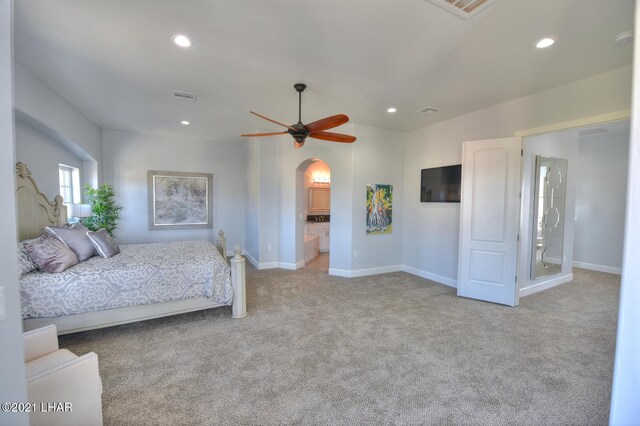 8551 River View Villas Dr Unit 15, Parker, AZ 85344 - carpeted bedroom featuring arched walkways, recessed lighting, baseboards, ceiling fan, and ensuite bath