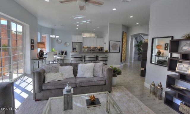 8551 River View Villas Dr Unit 15, Parker, AZ 85344 - living area featuring arched walkways, ceiling fan, recessed lighting, a chandelier, and baseboards