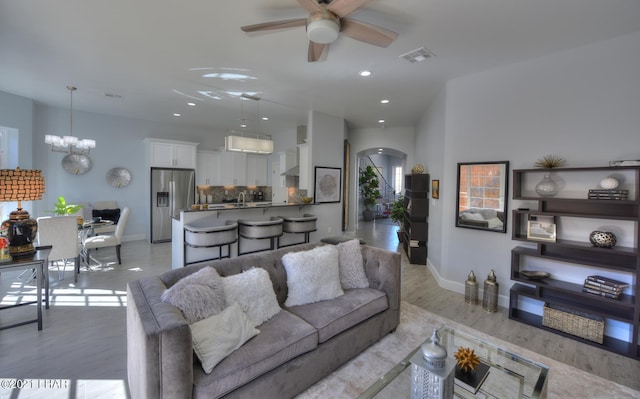 8551 River View Villas Dr Unit 15, Parker, AZ 85344 - living area with arched walkways, a ceiling fan, light wood-style flooring, baseboards, and recessed lighting