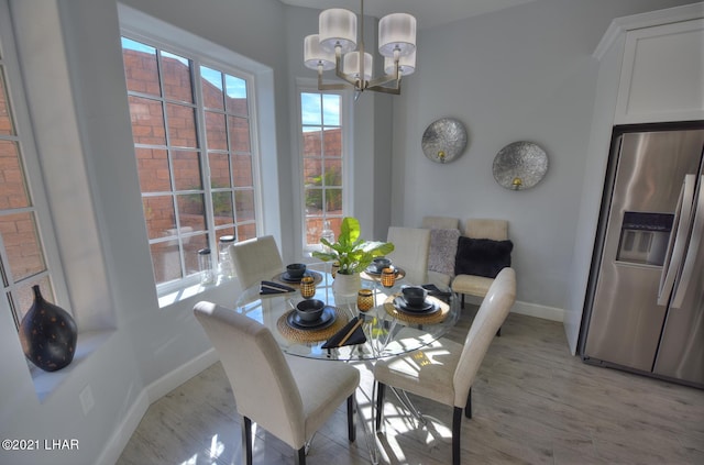 8551 River View Villas Dr Unit 15, Parker, AZ 85344 - dining area featuring baseboards, a chandelier, and light wood-style floors