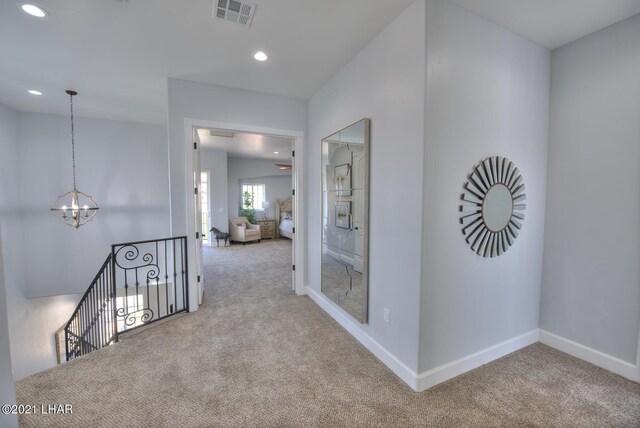 8551 River View Villas Dr Unit 15, Parker, AZ 85344 - hallway featuring carpet, a chandelier, an upstairs landing, baseboards, and recessed lighting