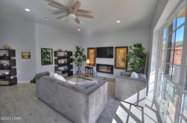 8551 River View Villas Dr Unit 15, Parker, AZ 85344 - living room featuring a glass covered fireplace, baseboards, ceiling fan, light wood-style floors, and recessed lighting