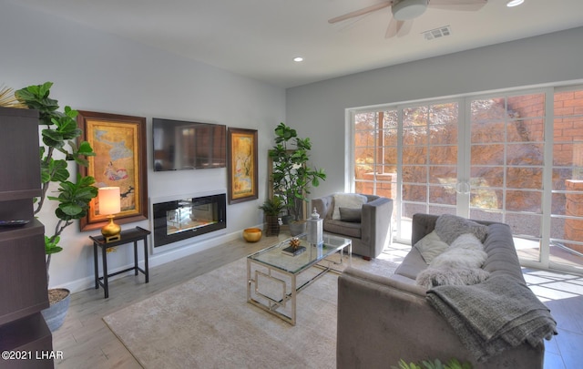 8551 River View Villas Dr Unit 15, Parker, AZ 85344 - living area with a ceiling fan, a glass covered fireplace, recessed lighting, baseboards, and wood finished floors