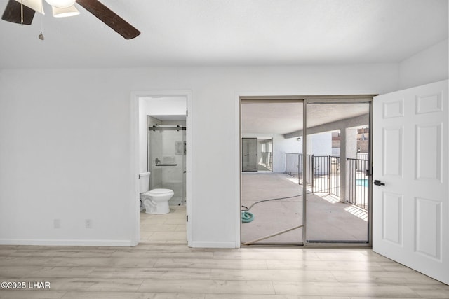 2870 Cisco Dr S, Lake Havasu City, AZ 86403 - unfurnished bedroom featuring wood finished floors, access to outside, connected bathroom, a closet, and a ceiling fan