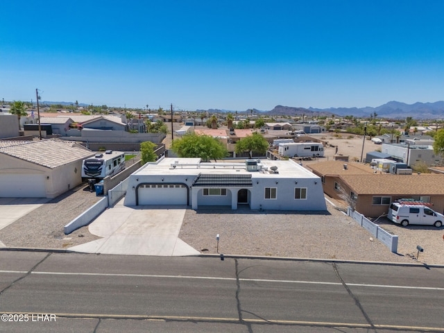 2870 Cisco Dr S, Lake Havasu City, AZ 86403 - view of front of property featuring concrete driveway, a residential view, a mountain view, and stucco siding