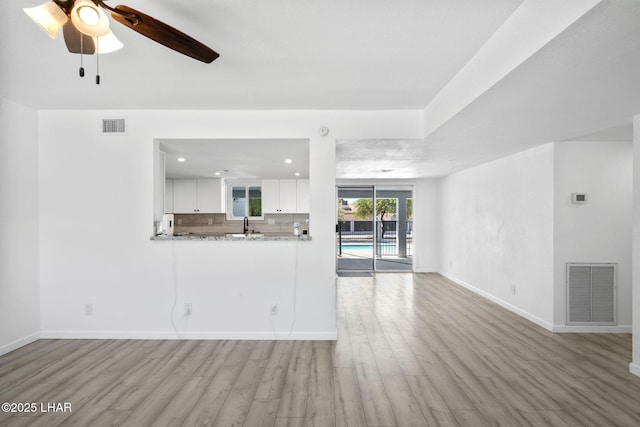 2870 Cisco Dr S, Lake Havasu City, AZ 86403 - unfurnished living room with wood finished floors, a ceiling fan, and recessed lighting