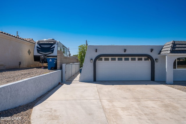2870 Cisco Dr S, Lake Havasu City, AZ 86403 - view of home's exterior featuring stucco siding, a gate, concrete driveway, and a garage