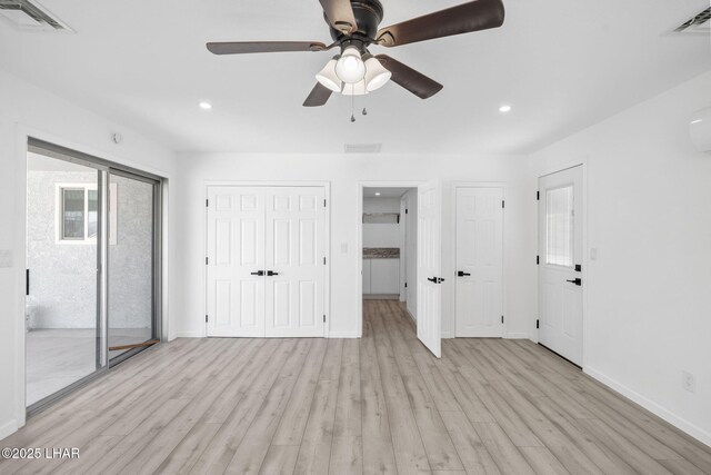 2870 Cisco Dr S, Lake Havasu City, AZ 86403 - unfurnished bedroom featuring light wood-style floors, recessed lighting, ceiling fan, and two closets
