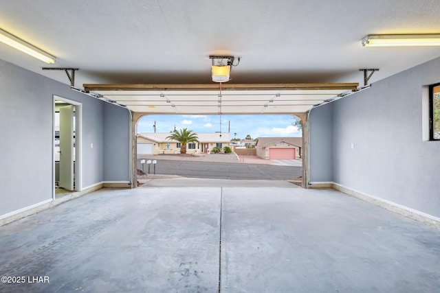 garage featuring baseboards and a garage door opener