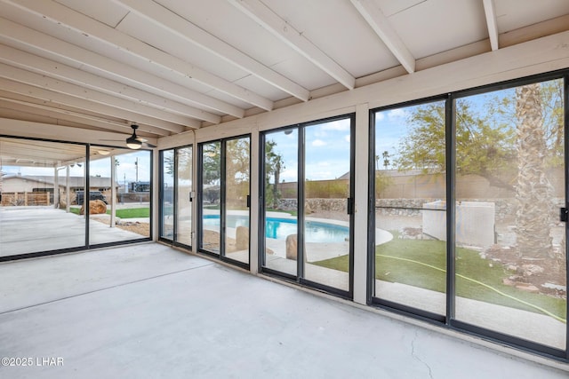 unfurnished sunroom featuring beamed ceiling