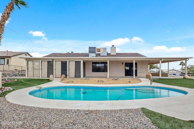 pool featuring a patio area and a yard