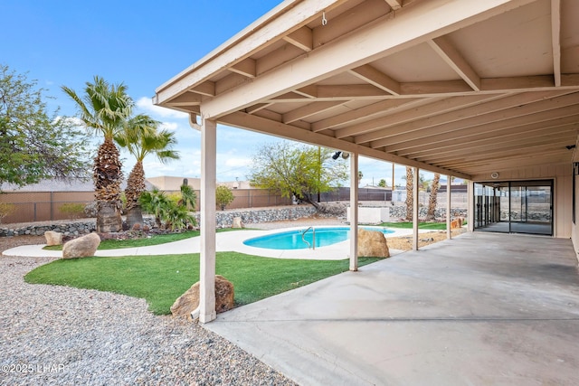 view of pool featuring a yard, a patio area, a fenced backyard, and a fenced in pool