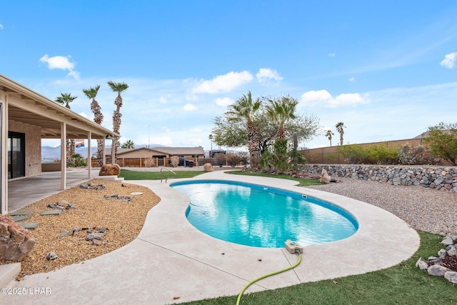 view of swimming pool featuring a patio area, a fenced backyard, and a fenced in pool