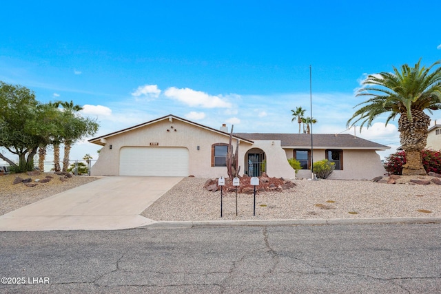 view of front of property with driveway, an attached garage, and stucco siding