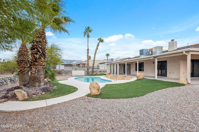 view of pool featuring a fenced in pool, a patio area, fence, and central AC unit