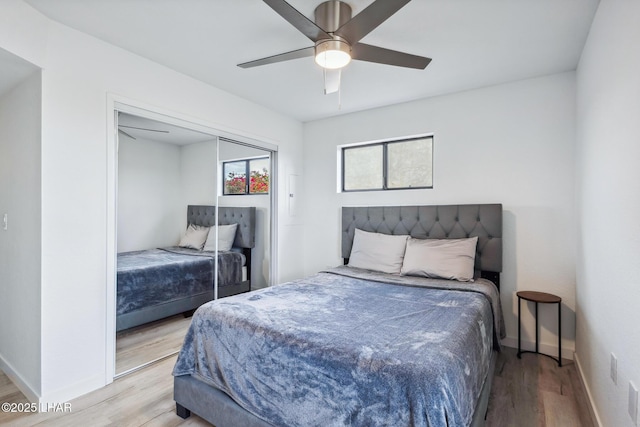 bedroom with ceiling fan, baseboards, and wood finished floors