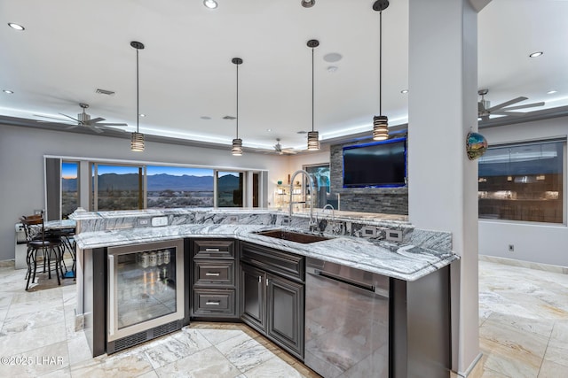 kitchen with wine cooler, stainless steel dishwasher, ceiling fan, and a sink