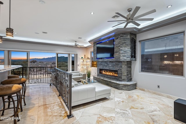 living room featuring a ceiling fan, baseboards, visible vents, recessed lighting, and an outdoor stone fireplace