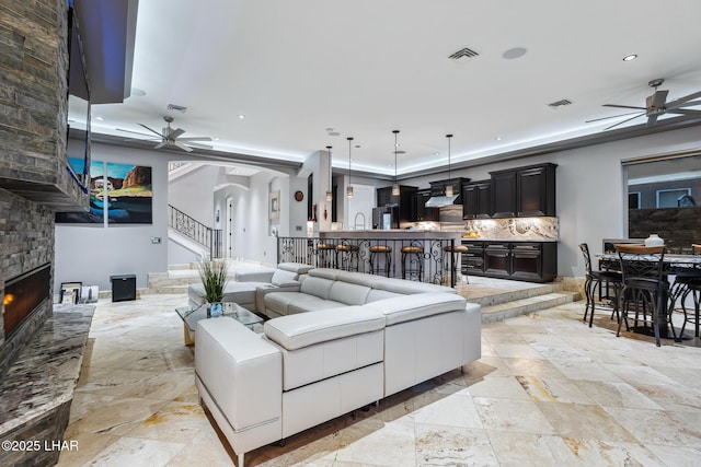 living room featuring visible vents and ceiling fan