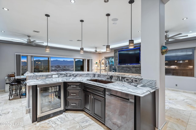 kitchen featuring a sink, wine cooler, stainless steel dishwasher, and ceiling fan