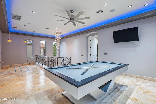 game room featuring a tray ceiling, arched walkways, visible vents, and ceiling fan