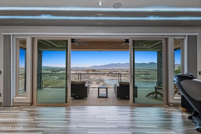 entryway featuring a mountain view, a wealth of natural light, and ceiling fan