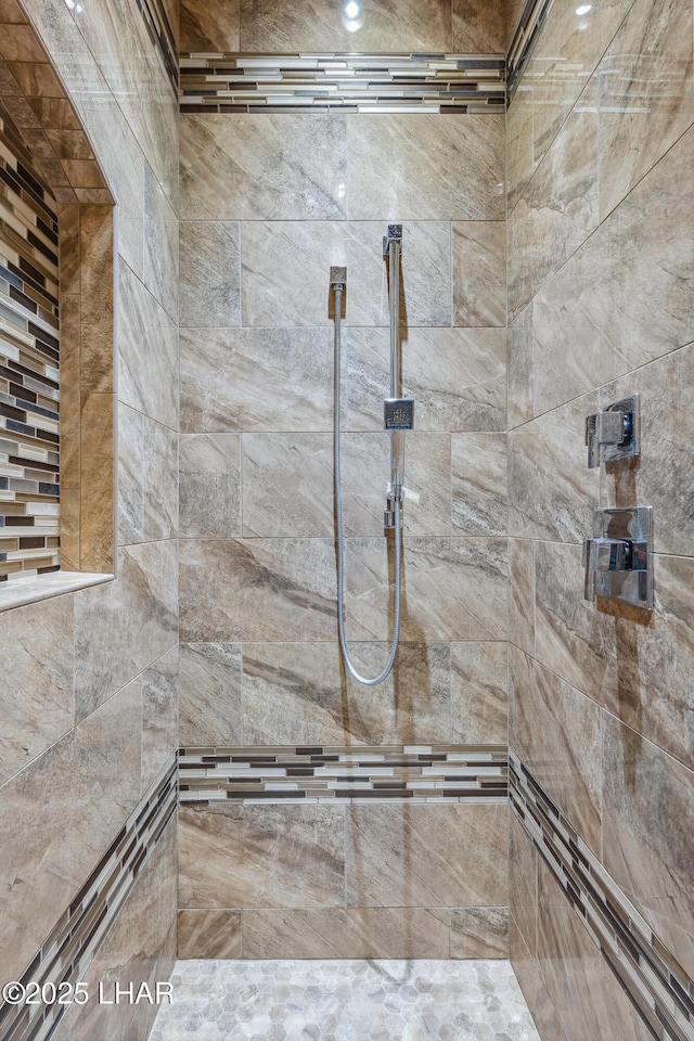 bathroom with tiled shower