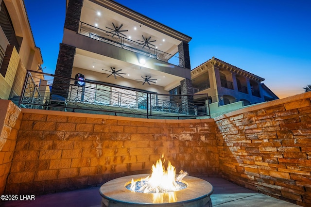 view of patio featuring a fire pit and ceiling fan