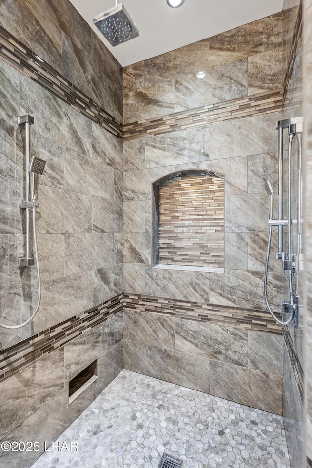 full bath with a tile shower