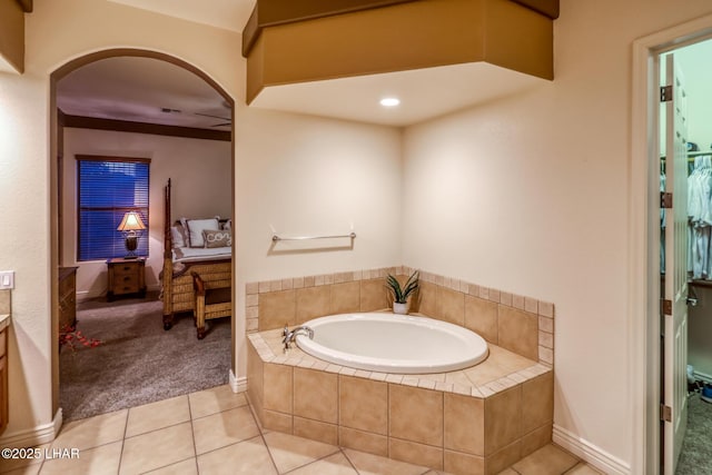 ensuite bathroom featuring tile patterned flooring, ensuite bath, and a bath