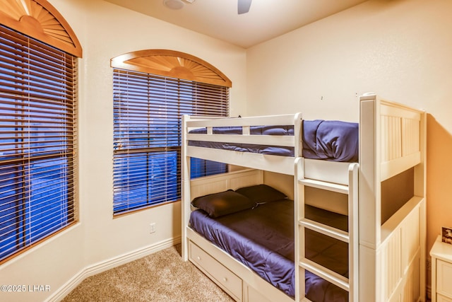 bedroom with carpet flooring, a ceiling fan, and baseboards