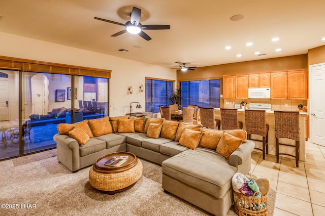 living area with light tile patterned flooring, visible vents, recessed lighting, and a ceiling fan