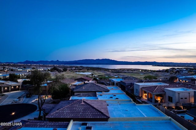 aerial view at dusk with a water and mountain view