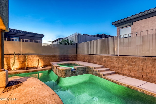 view of pool featuring a pool with connected hot tub and fence