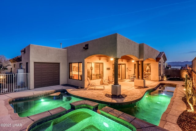 view of pool featuring a pool with connected hot tub, a patio, and fence