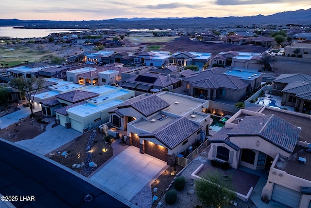 drone / aerial view featuring a residential view and a water and mountain view