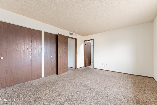 2780 Cisco Dr N, Lake Havasu City, AZ 86403 - unfurnished bedroom with carpet floors, a textured ceiling, visible vents, and multiple closets