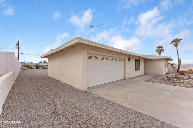 2780 Cisco Dr N, Lake Havasu City, AZ 86403 - view of front of house featuring an attached garage, driveway, and stucco siding