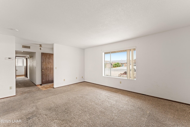 2780 Cisco Dr N, Lake Havasu City, AZ 86403 - carpeted empty room featuring visible vents, baseboards, and a textured ceiling