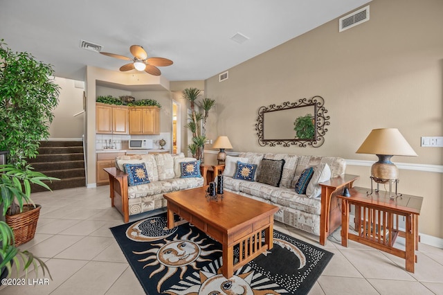 8480 Miraleste Shores Dr, Parker, AZ 85344 - living area featuring light tile patterned flooring, ceiling fan, and stairway