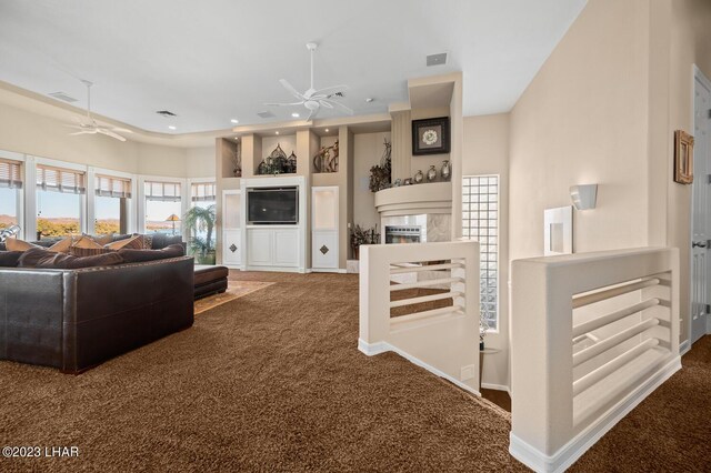 8480 Miraleste Shores Dr, Parker, AZ 85344 - carpeted living room featuring ceiling fan, a glass covered fireplace, and recessed lighting
