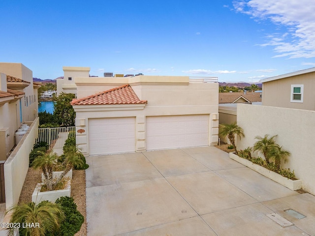 8480 Miraleste Shores Dr, Parker, AZ 85344 - view of front of house with stucco siding, driveway, a tiled roof, and an attached garage