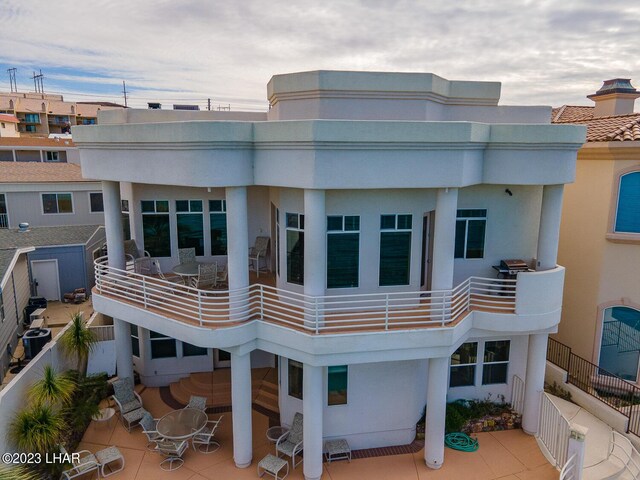 8480 Miraleste Shores Dr, Parker, AZ 85344 - back of property featuring stucco siding, a balcony, and a patio