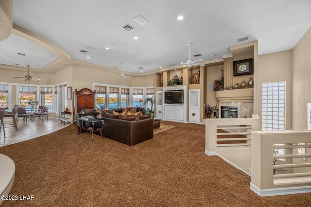 8480 Miraleste Shores Dr, Parker, AZ 85344 - living room with ceiling fan, recessed lighting, carpet, a fireplace, and ornamental molding