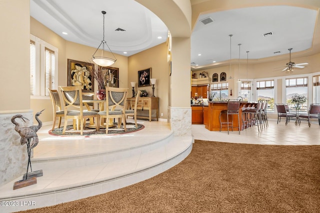 8480 Miraleste Shores Dr, Parker, AZ 85344 - dining area featuring light tile patterned floors, recessed lighting, a tray ceiling, plenty of natural light, and light carpet