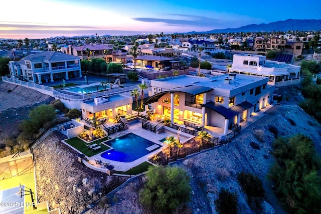 aerial view at dusk featuring a mountain view